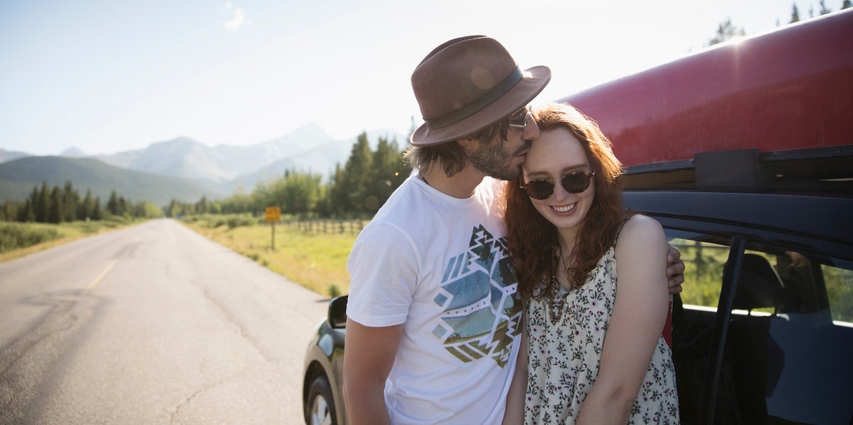 how to make your wife hapy man kissing woman's head against red car