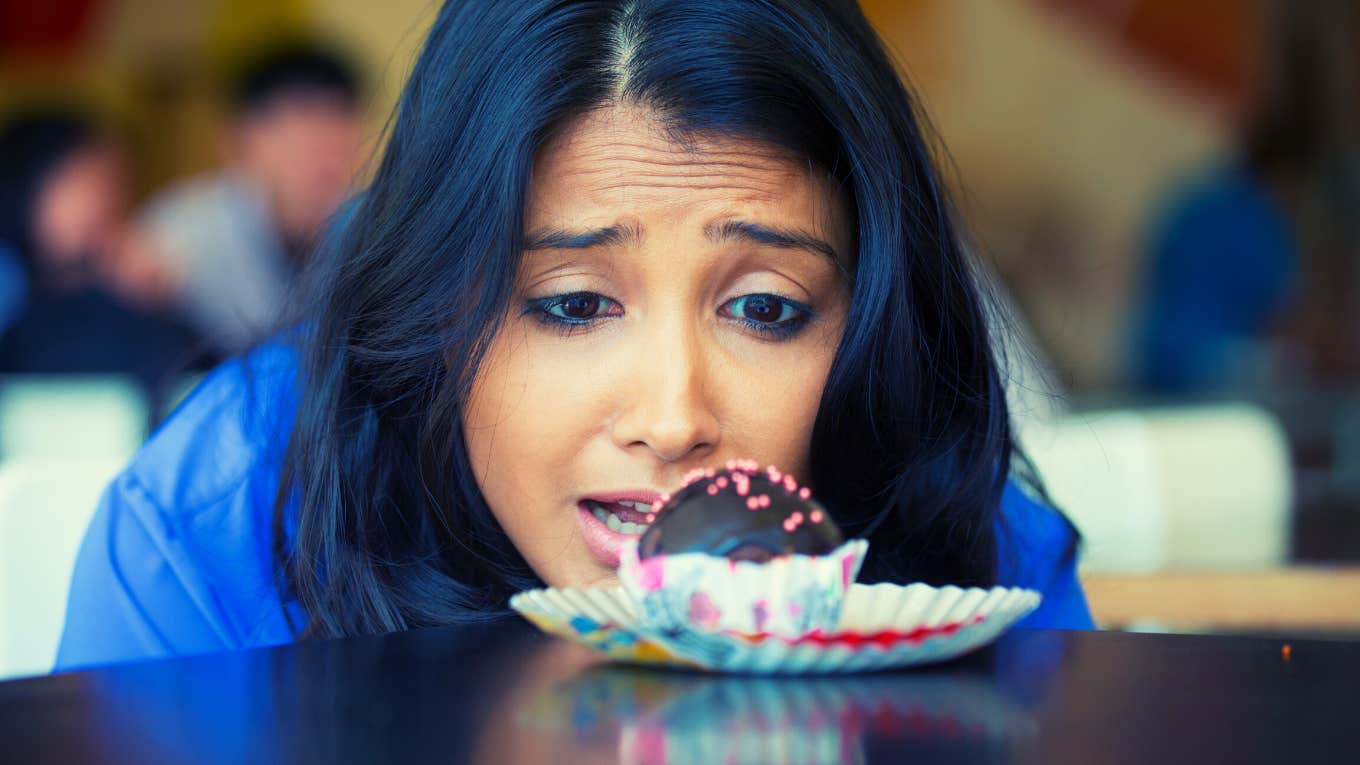 Closeup portrait of woman in blue shirt craving fudge