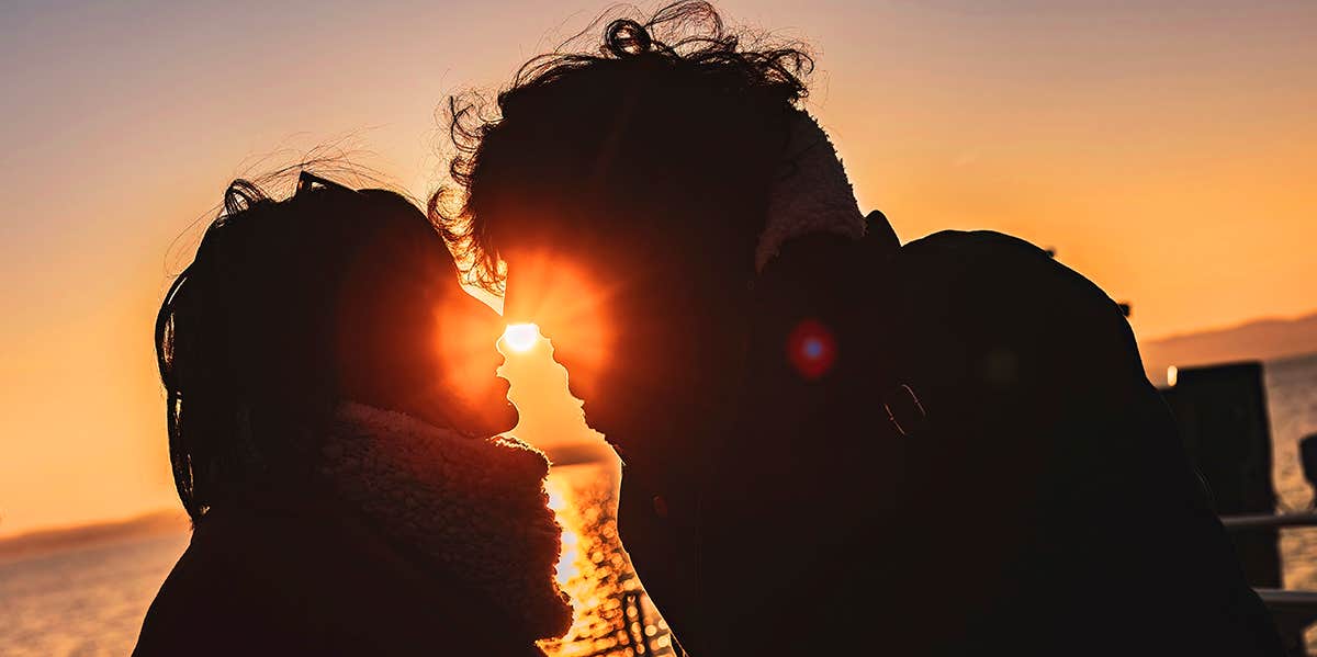 couple kissing in sunset