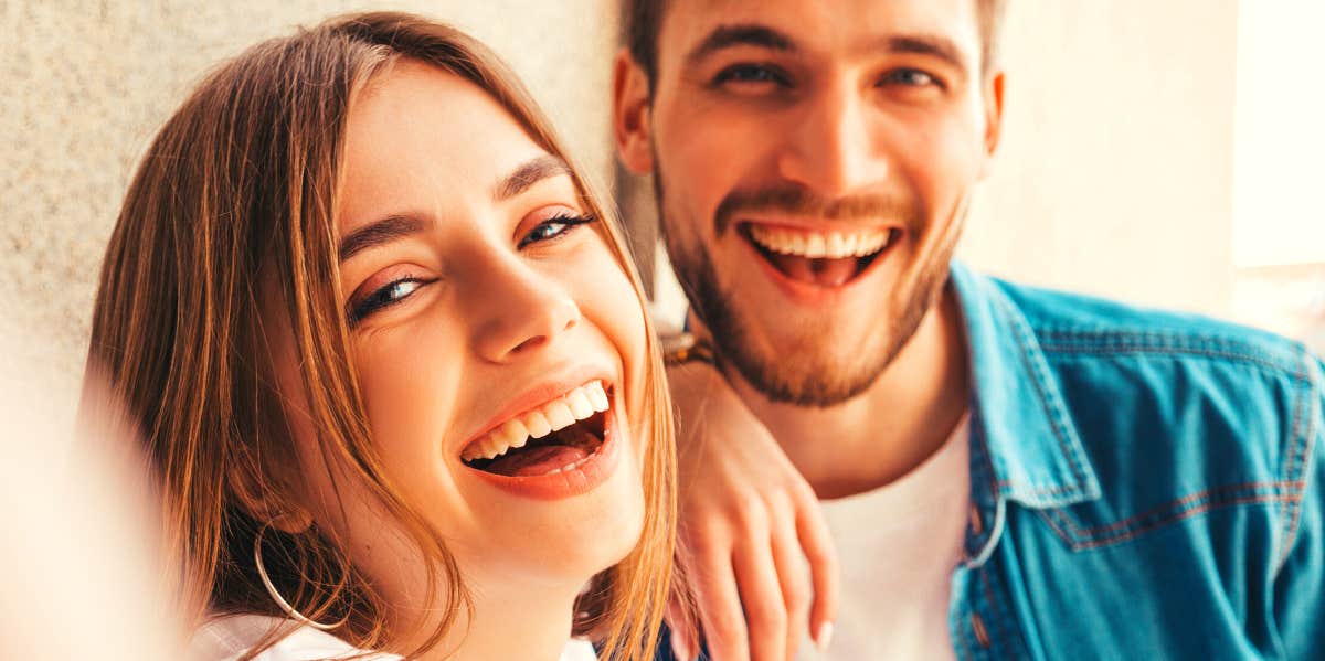 man and woman smiling at the camera