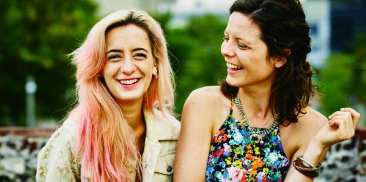 two women hanging out and smiling 