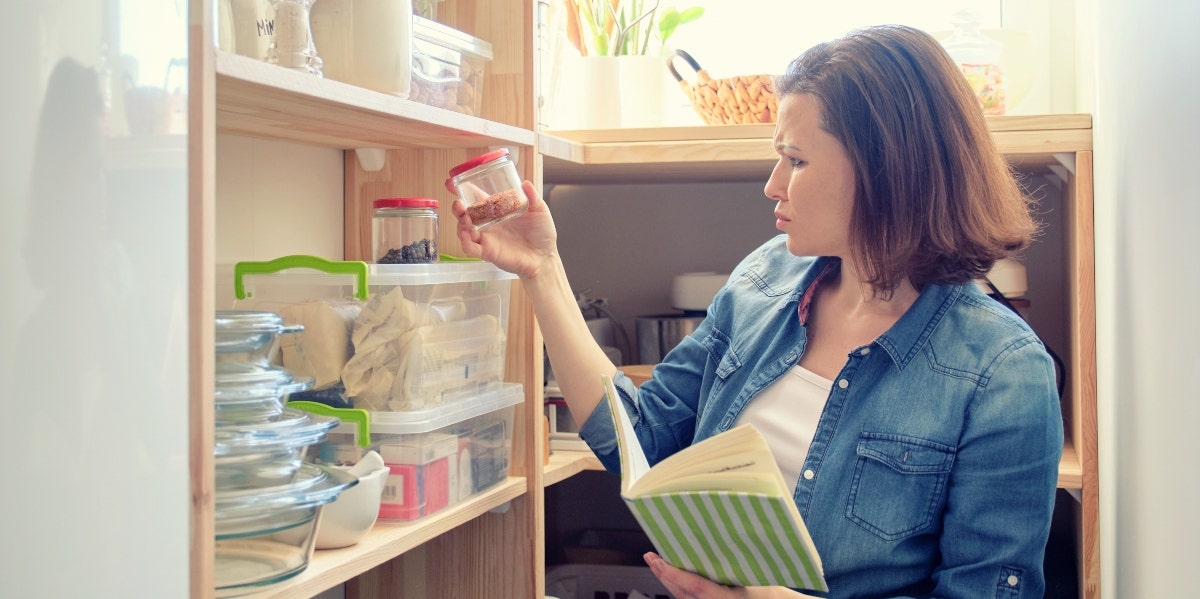 woman with a book looking at ingredients