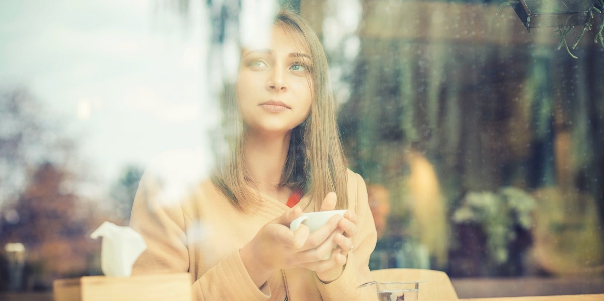 how to practice spirituality woman drinking tea looking out window
