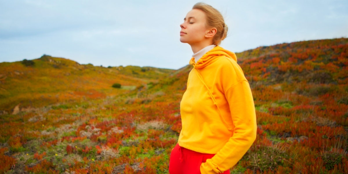 how to pray the rosary relaxed woman in yellow sweater outdoors