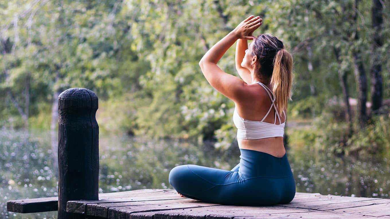 girl meditating by river