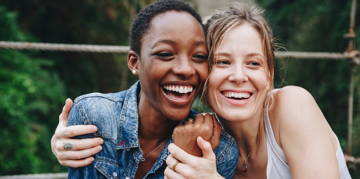 two smiling women hugging