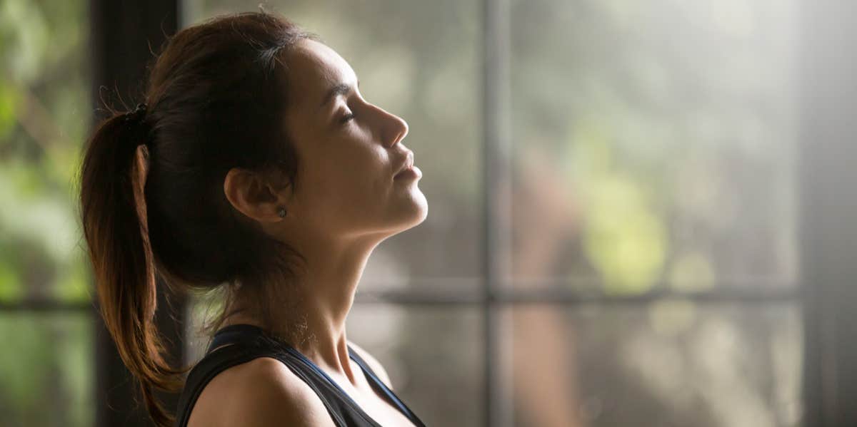 A 2-Minute Solution To Feeling Less Stressed When Even Just Thinking About It Is Too Stressful woman doing breathing exercise