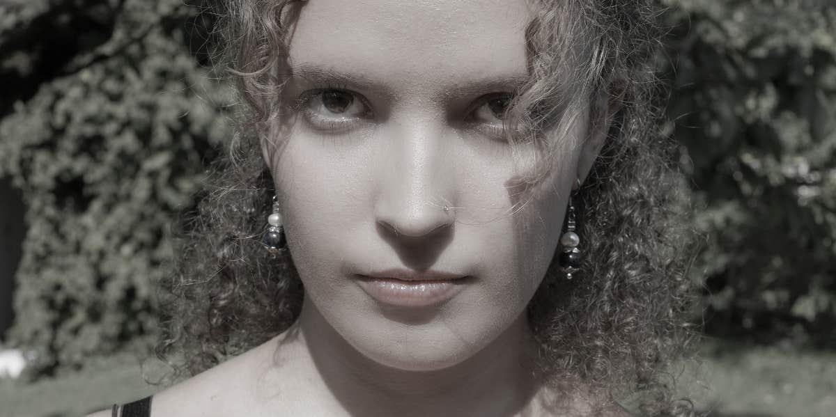 How To Spot A Psychopath Through 5 Telltale Traits, According To Research woman with intense eyes black and white photo