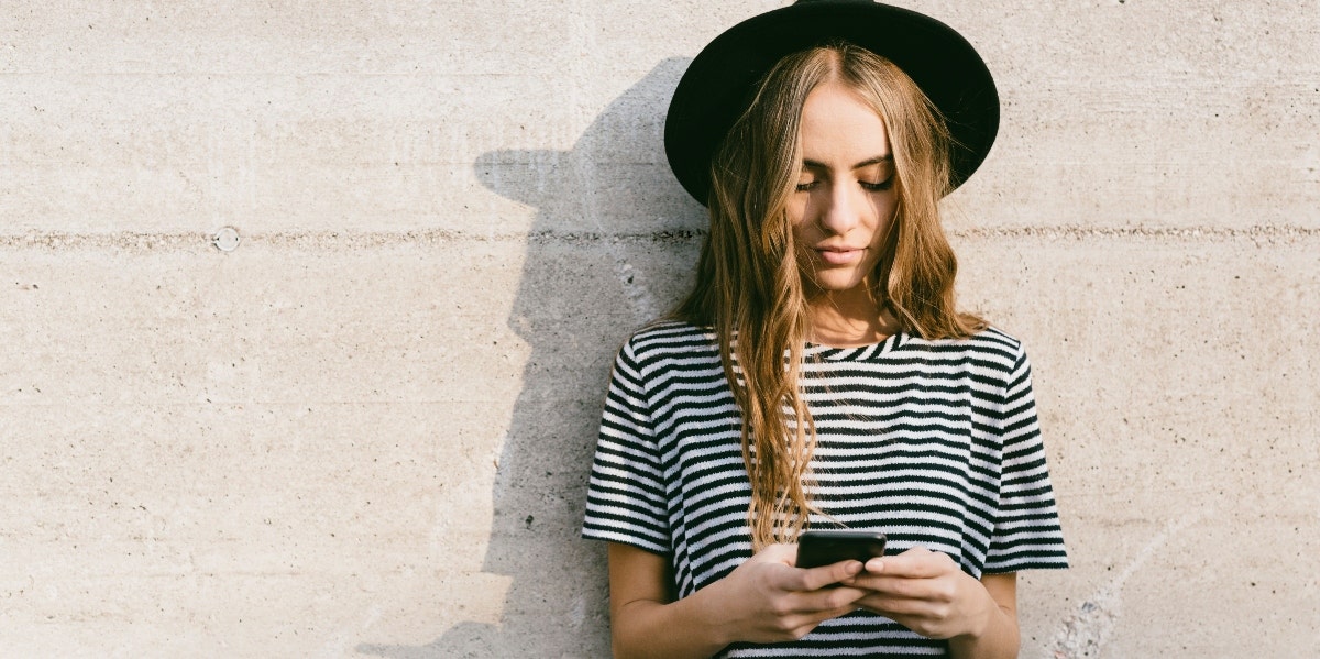 How To Apologize After Ghosting Someone woman outside texting on cell phone
