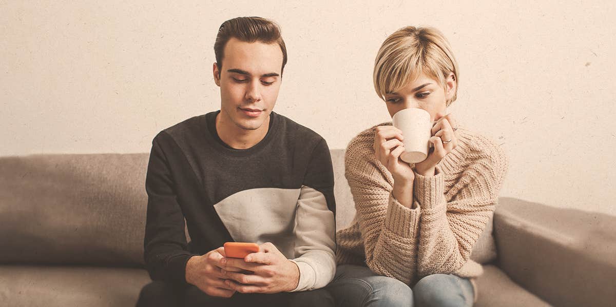 man texting beside a woman