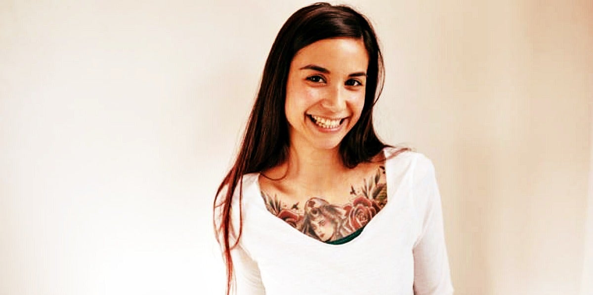 young woman with long brown hair smiles at the camera