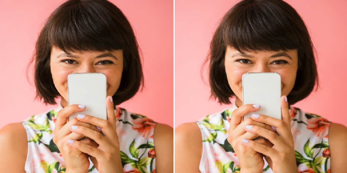 woman looking at her phone excited to learn how to text a guy