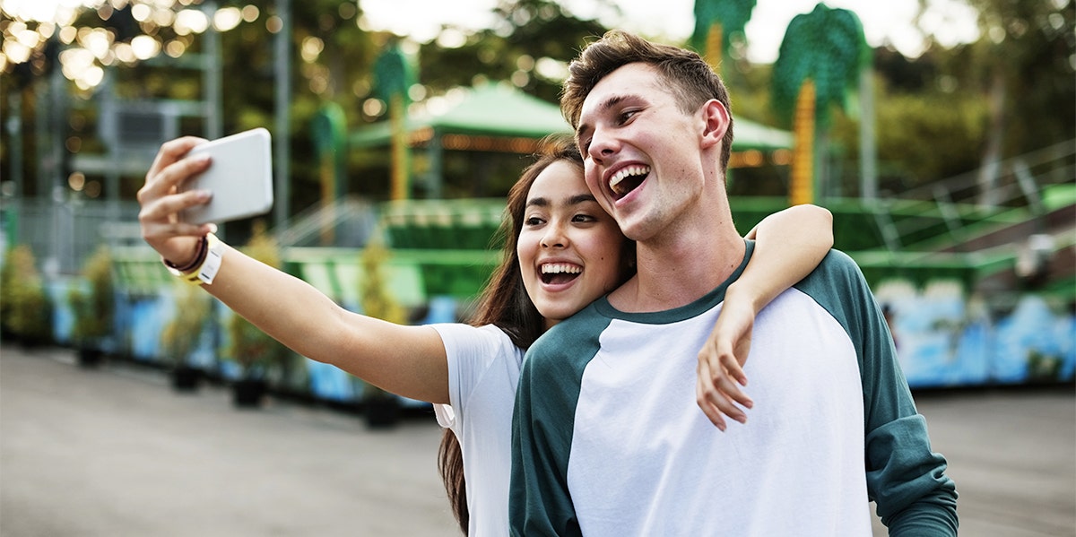 young man taking selfie with woman