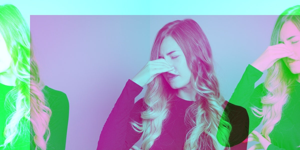 How To Clear A Stuffy Nose In 2 Minutes Flat: 3 Smart Hacks woman holding her nose