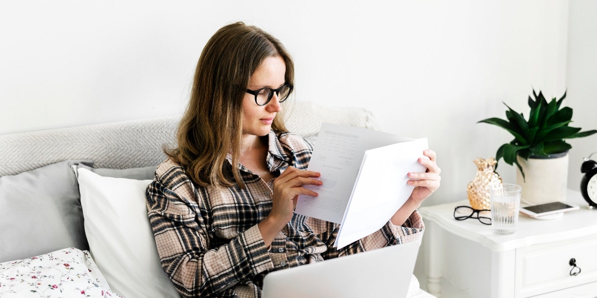 woman working from home in bed