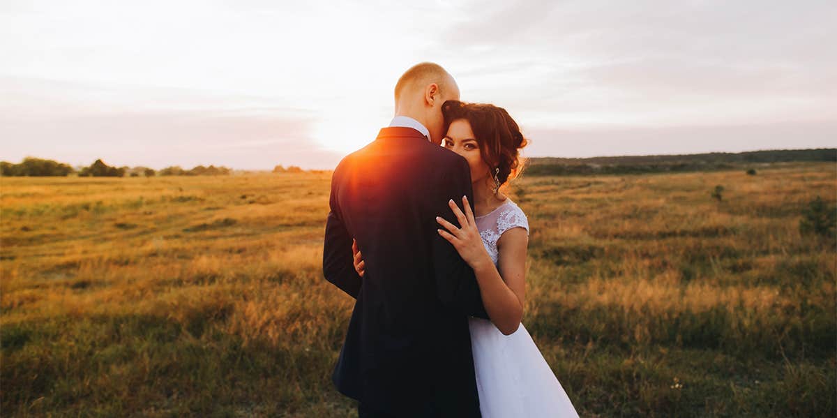 bride and groom hugging