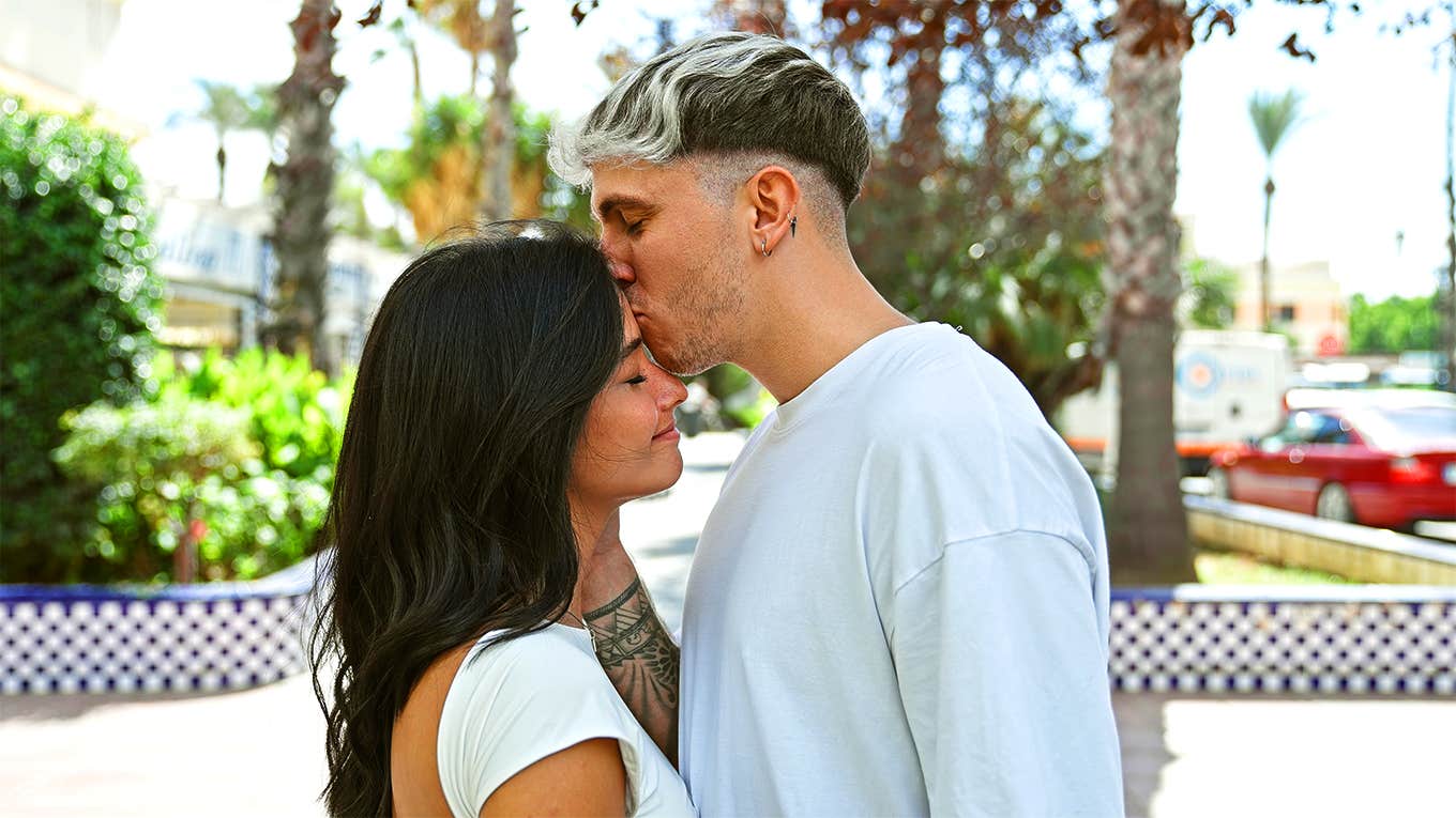 guy kissing girl's forehead