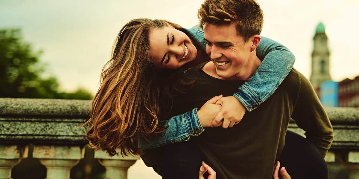 man carrying woman on his back