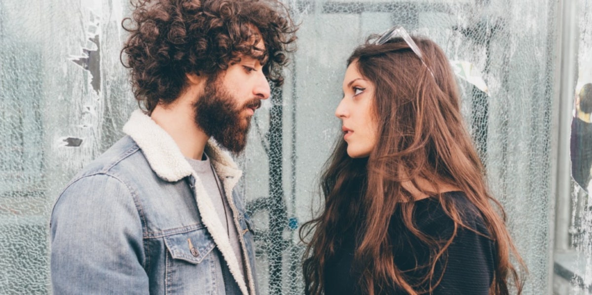 4 Ways You Hurt Your Partner And How To Respond couple facing each other looking sad
