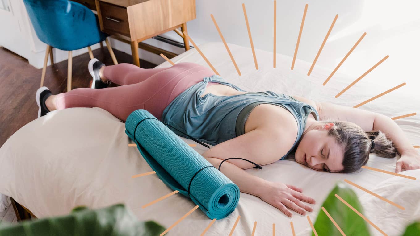 Woman laying on bed sleeping after yoga