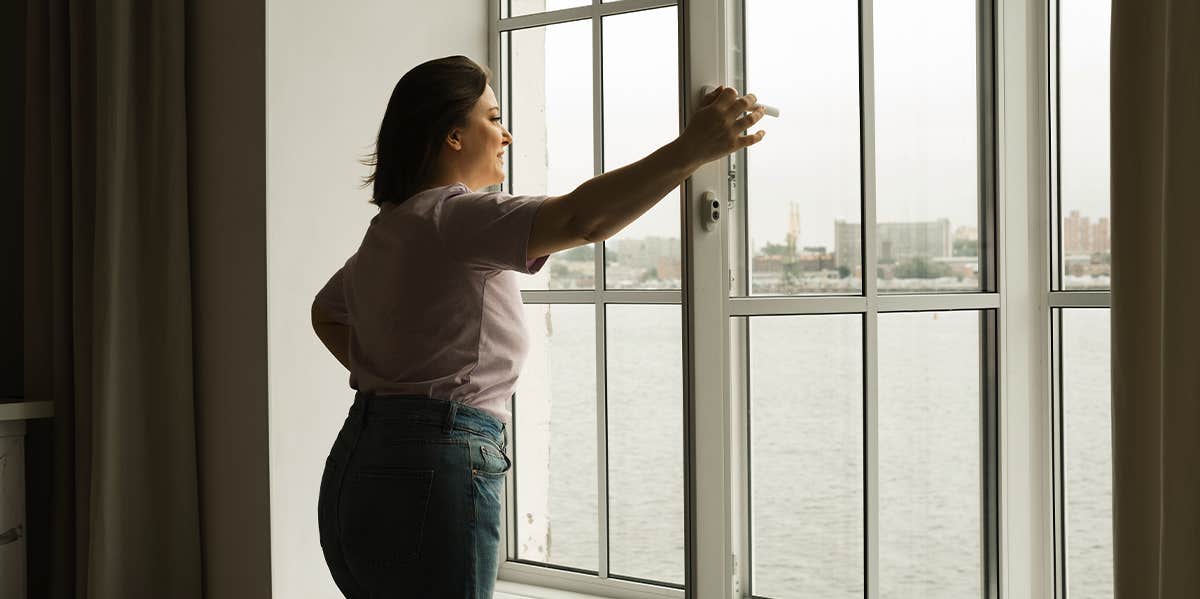 woman looking out window