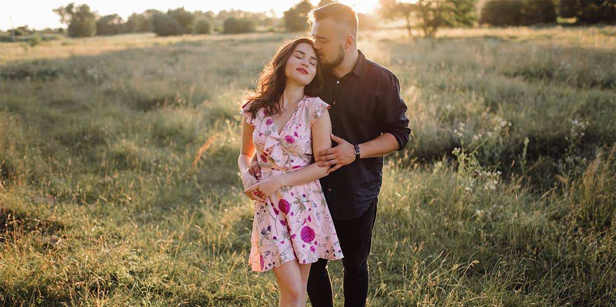 man and woman in field together