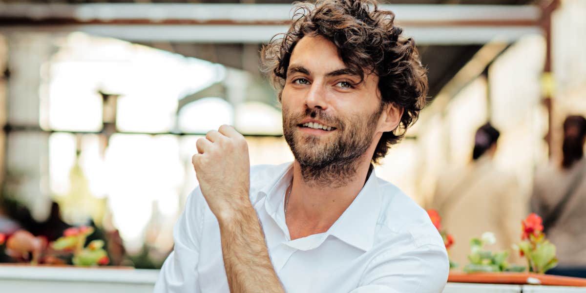 handsome man with devilsh smile in cafe