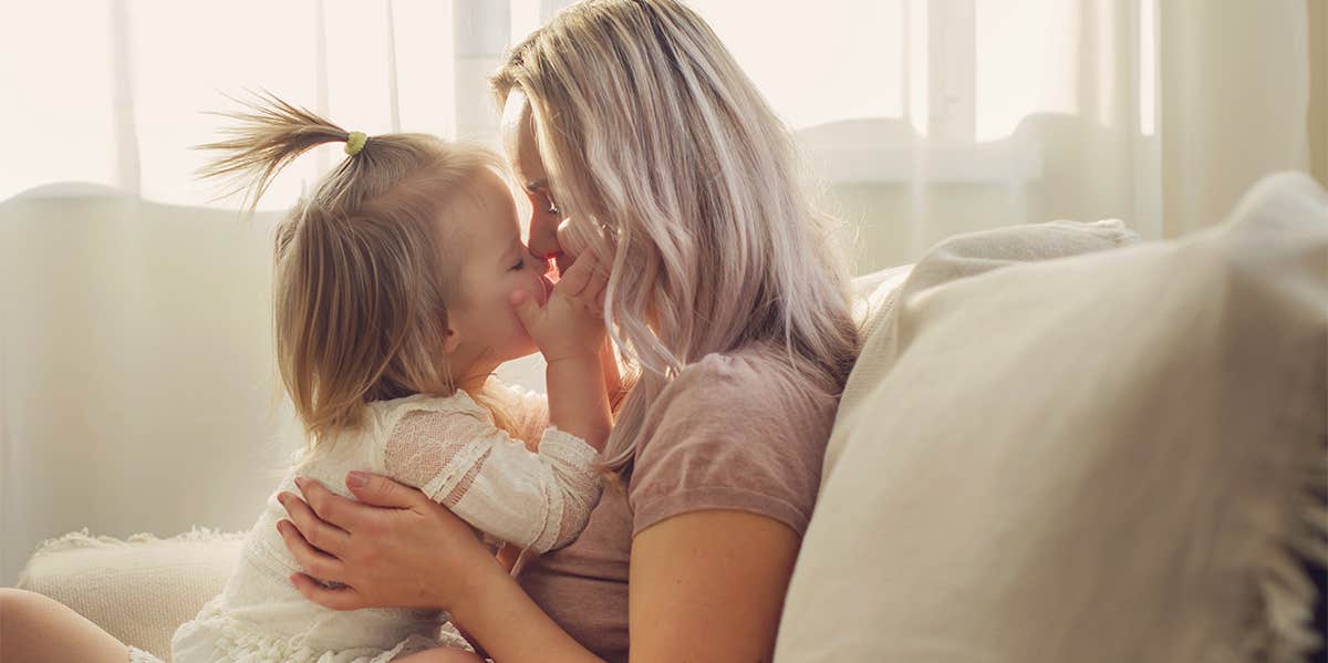 single mom holding daughter