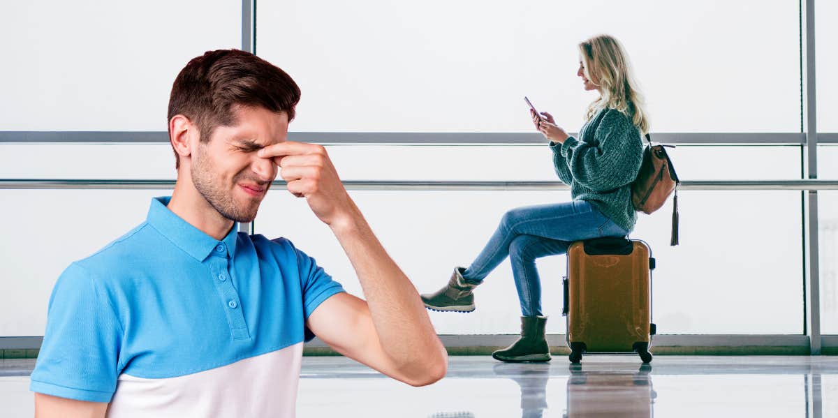 man upset over woman sitting on luggage at airport