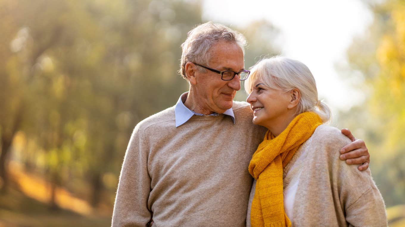 Elderly Husband Learns to Blow Dry Wife's Hair elderly couple hugging outside