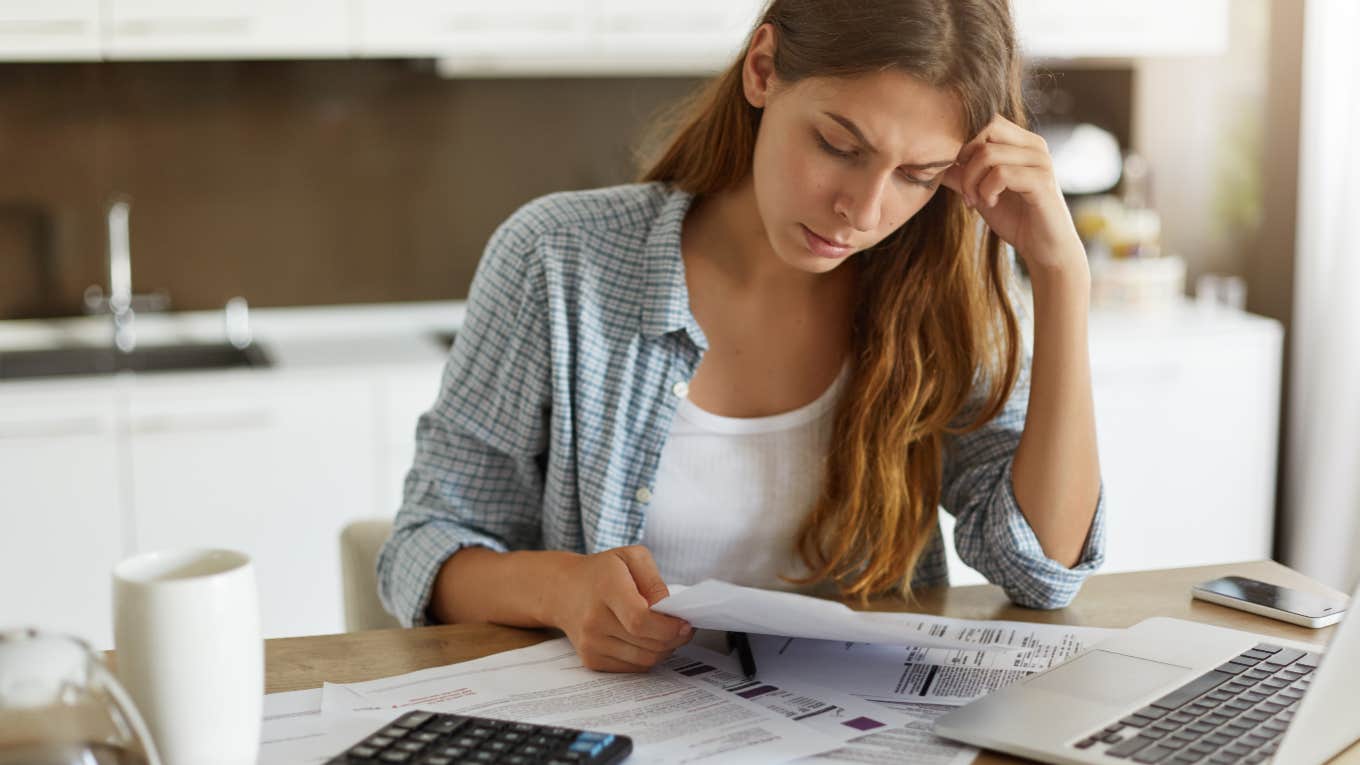 confused woman paying bills