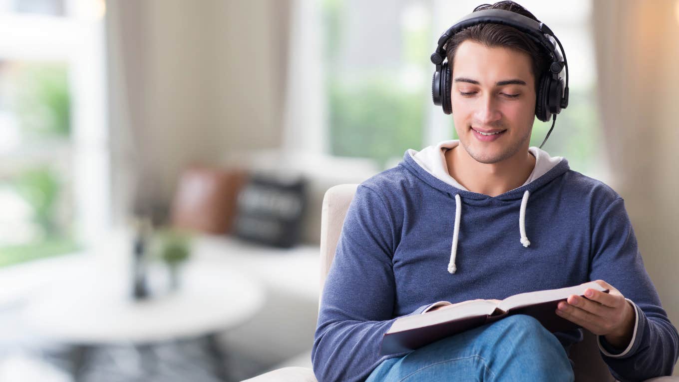 Adult man reading a comic book. 