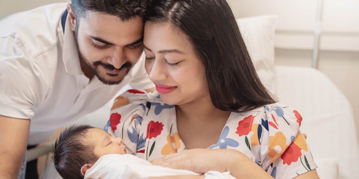 parents holding newborn baby