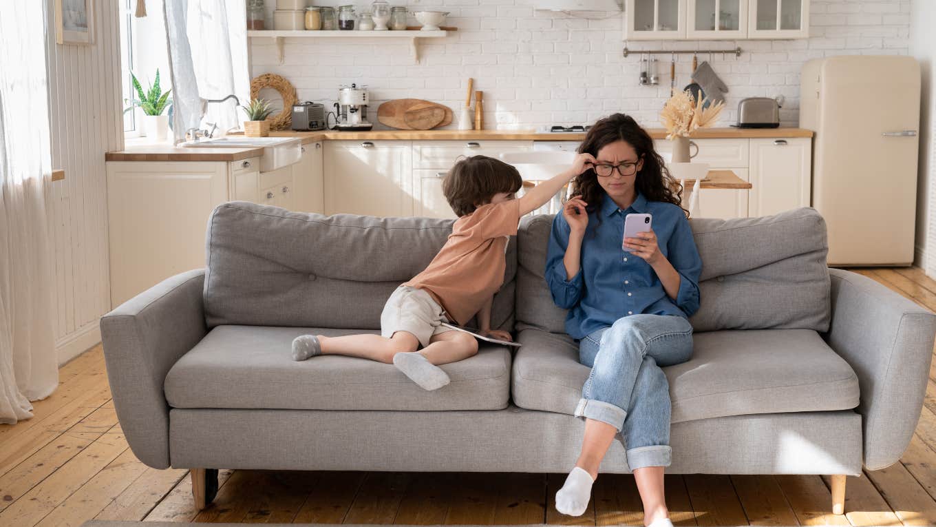 mom on phone while son tries to get her attention