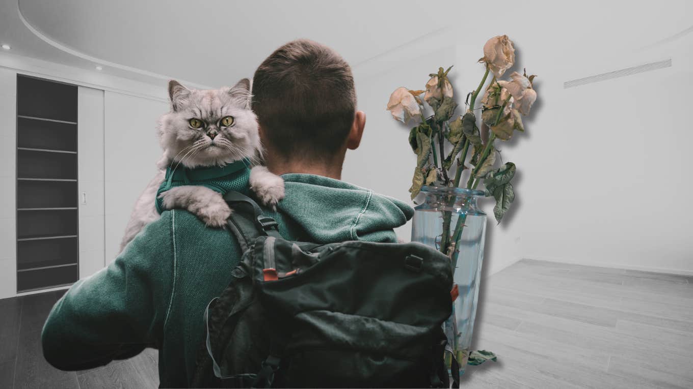 Man holding a cat with a backpack