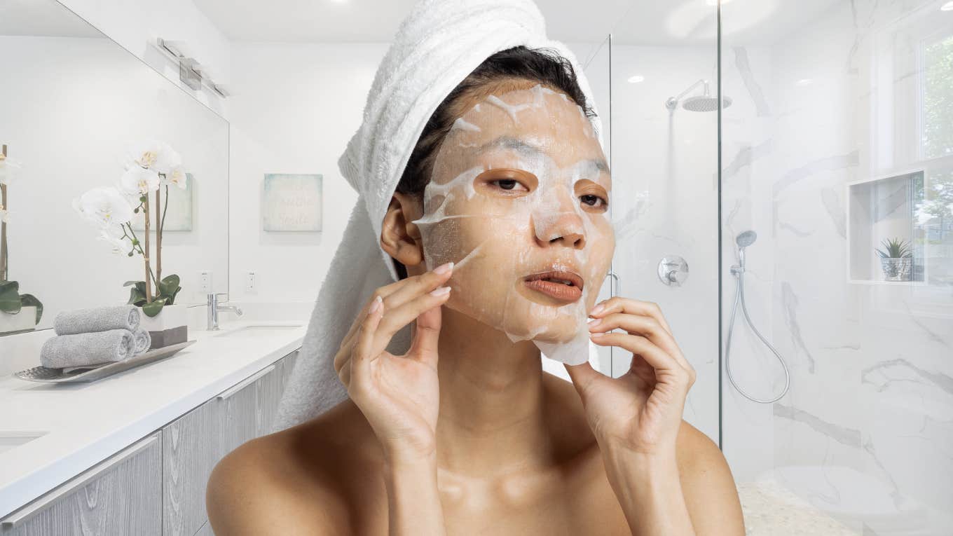 Woman putting on a face mask after showering. 