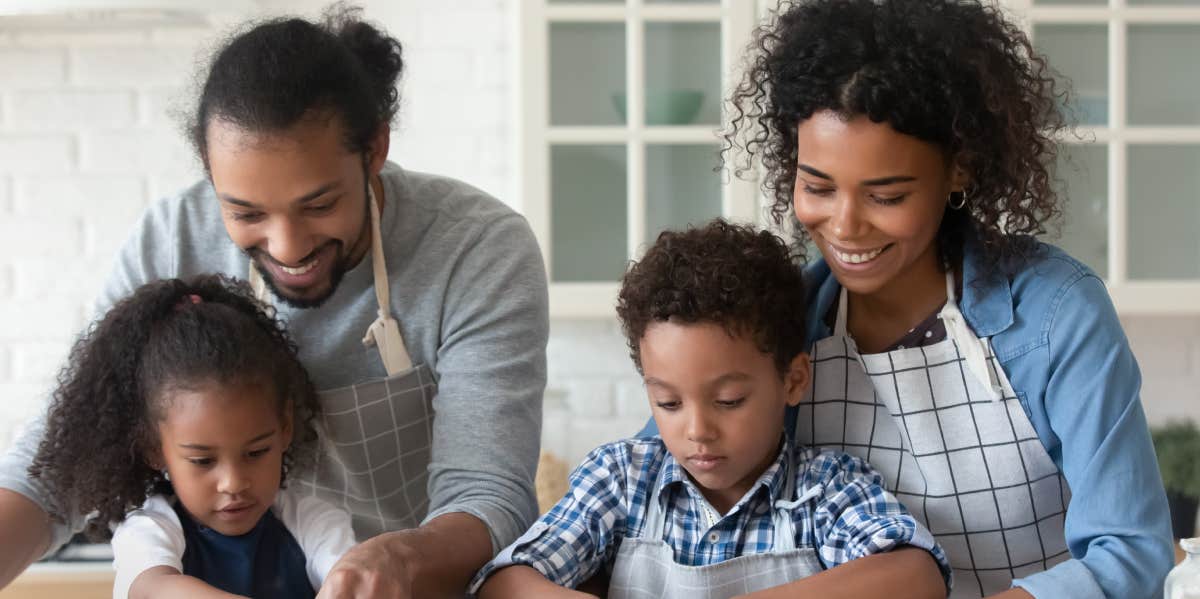 couple and children cooking together in their kitchen