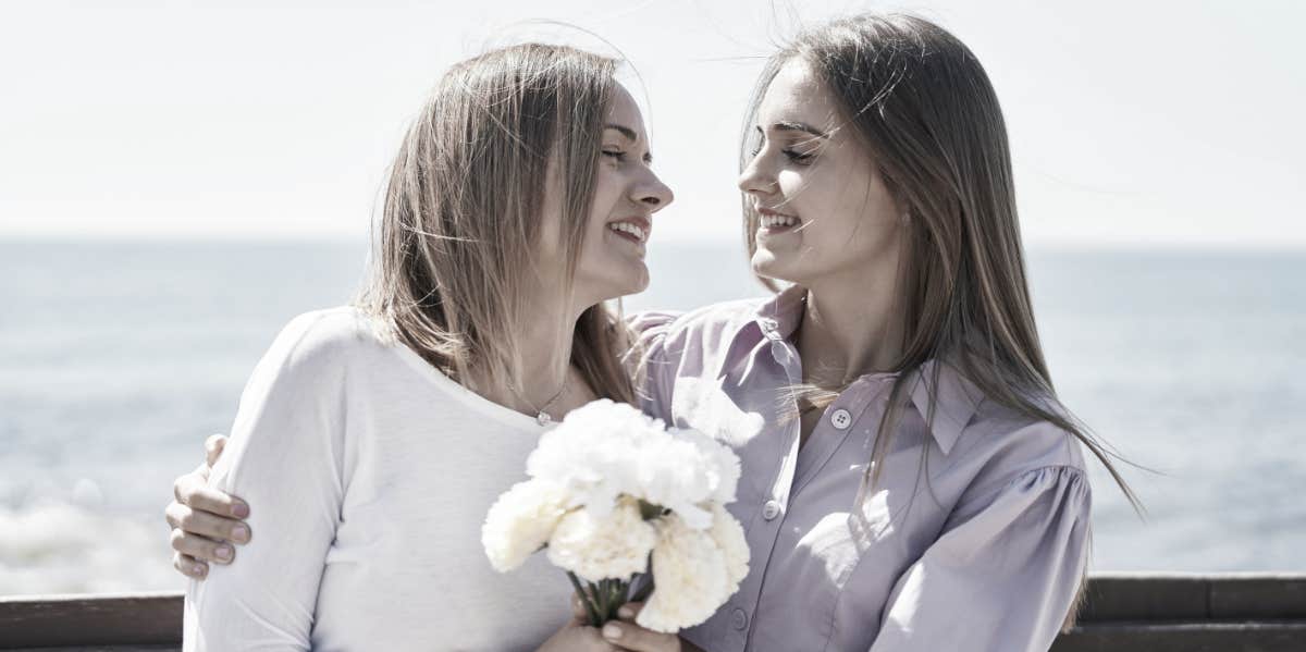 mother and daughter holding flowers