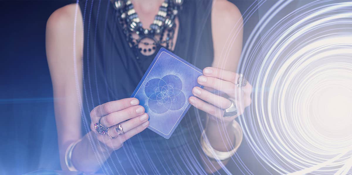 woman holding tarot card