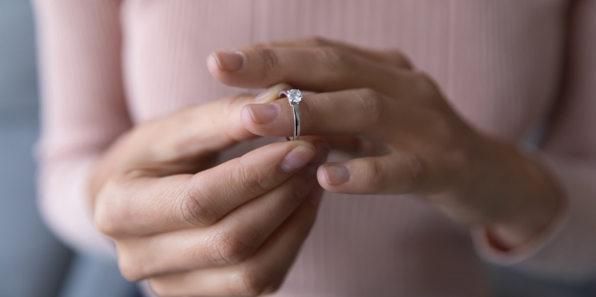 woman touching her engagement ring
