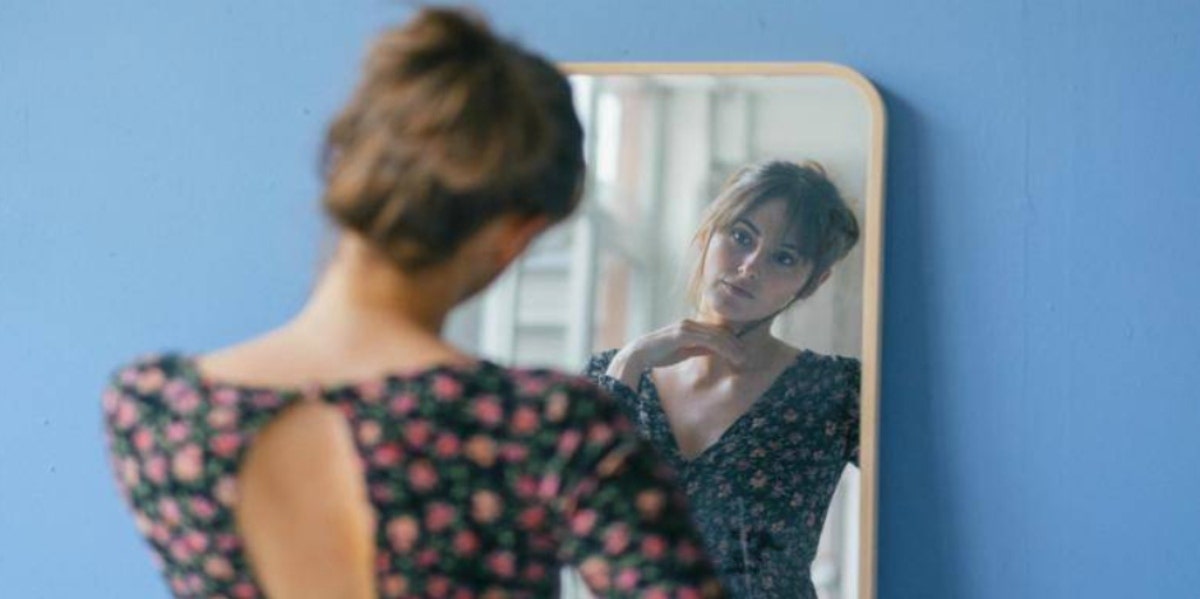 woman looking in the mirror