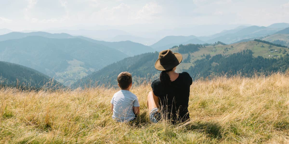 mother and son looking at mountain view