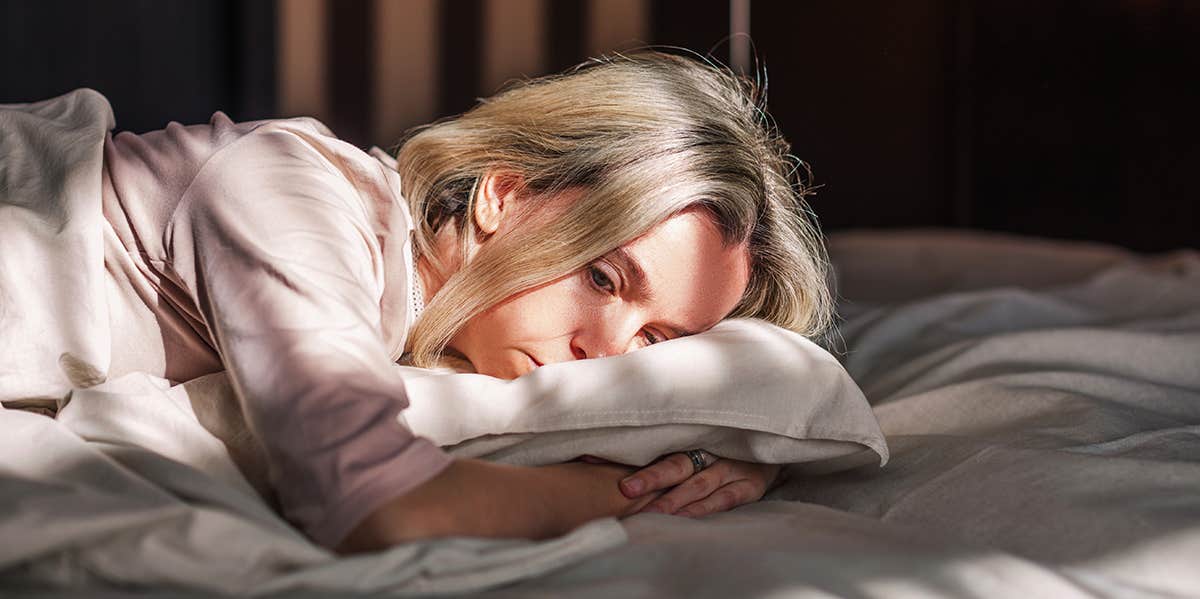 woman laying on bed