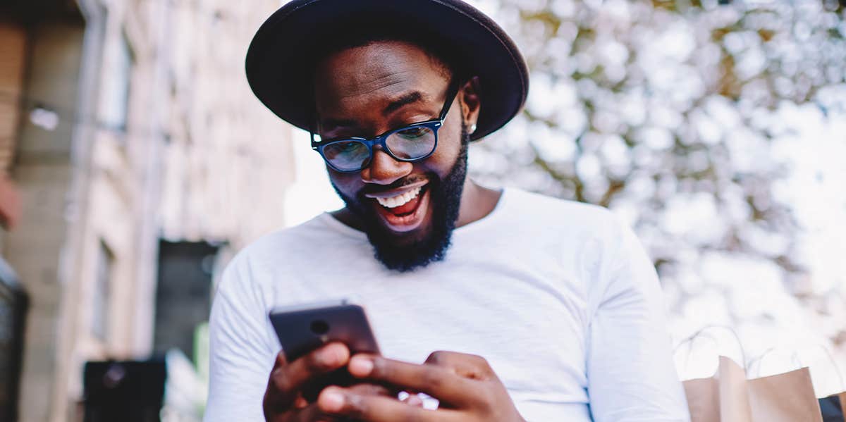 man looking at phone surprised