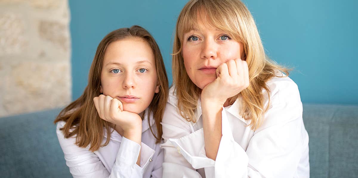 mother and daughter posing for photo