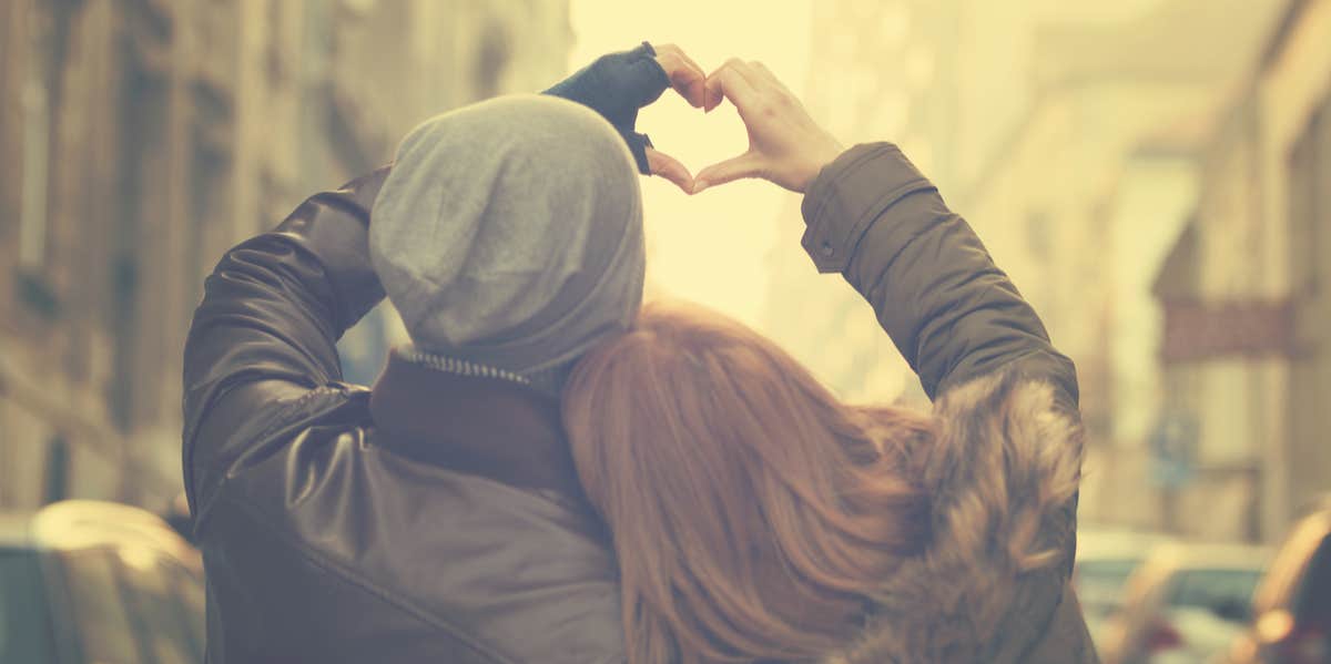 couple in love making a heart with their hands