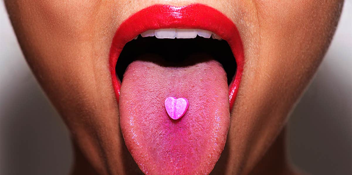 What Happened When I Tried A 'Miracle Berry' That Tricks Your Taste Buds woman taking pink tablet