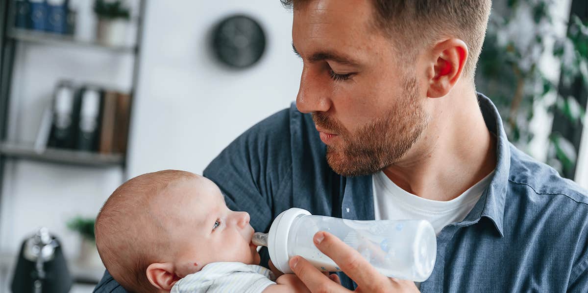 father bottle feeding baby