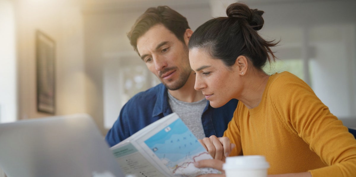 woman and man looking at map 