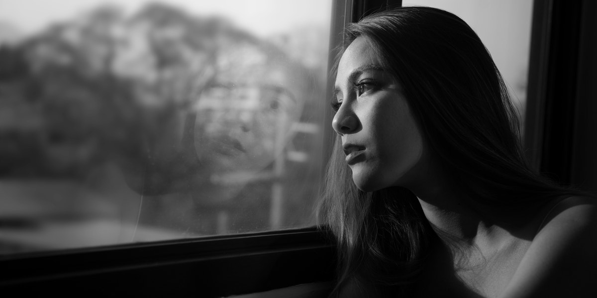 woman looking out window